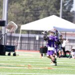 A lacrosse player shooting on the goal.