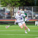 A lacrosse player in a white jersey.